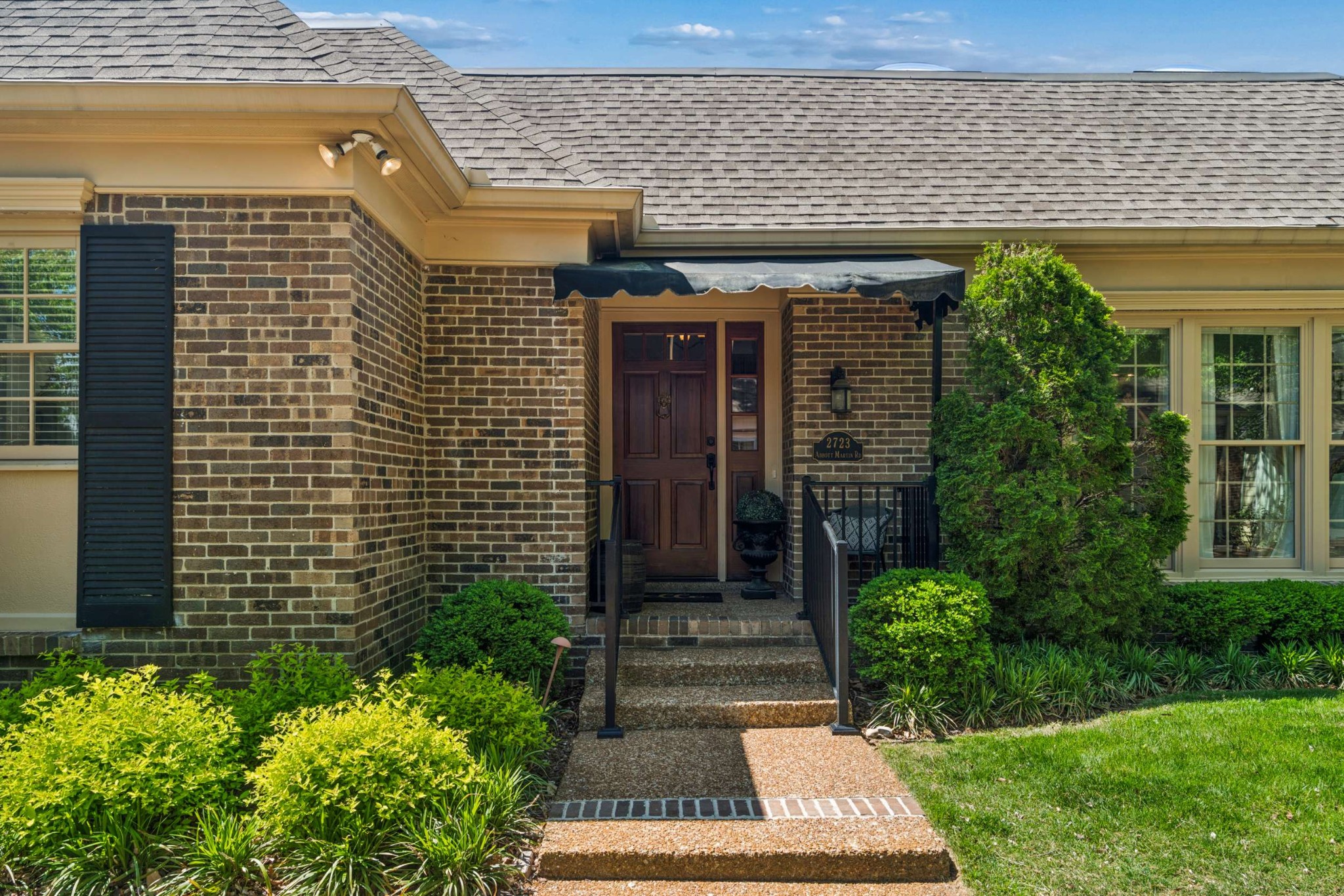 2723 Abbott Martin Road Nashville, TN 37215 - Photo 3 of 45 a front view of a house with a garden