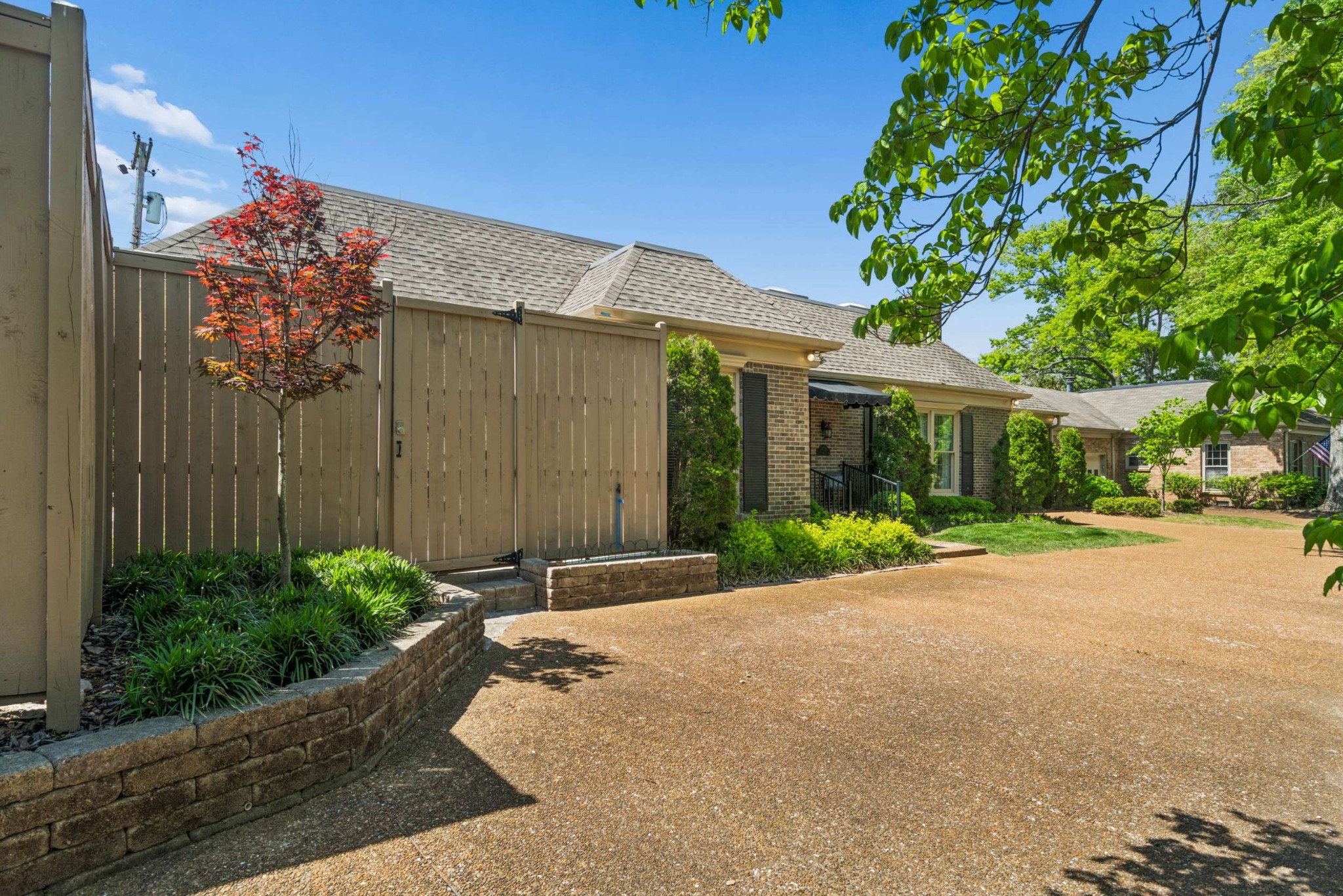 2723 Abbott Martin Road Nashville, TN 37215 - Photo 45 of 45 a view of a house with a small yard and potted plants
