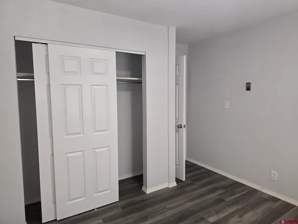 a small space with wooden floor and a window