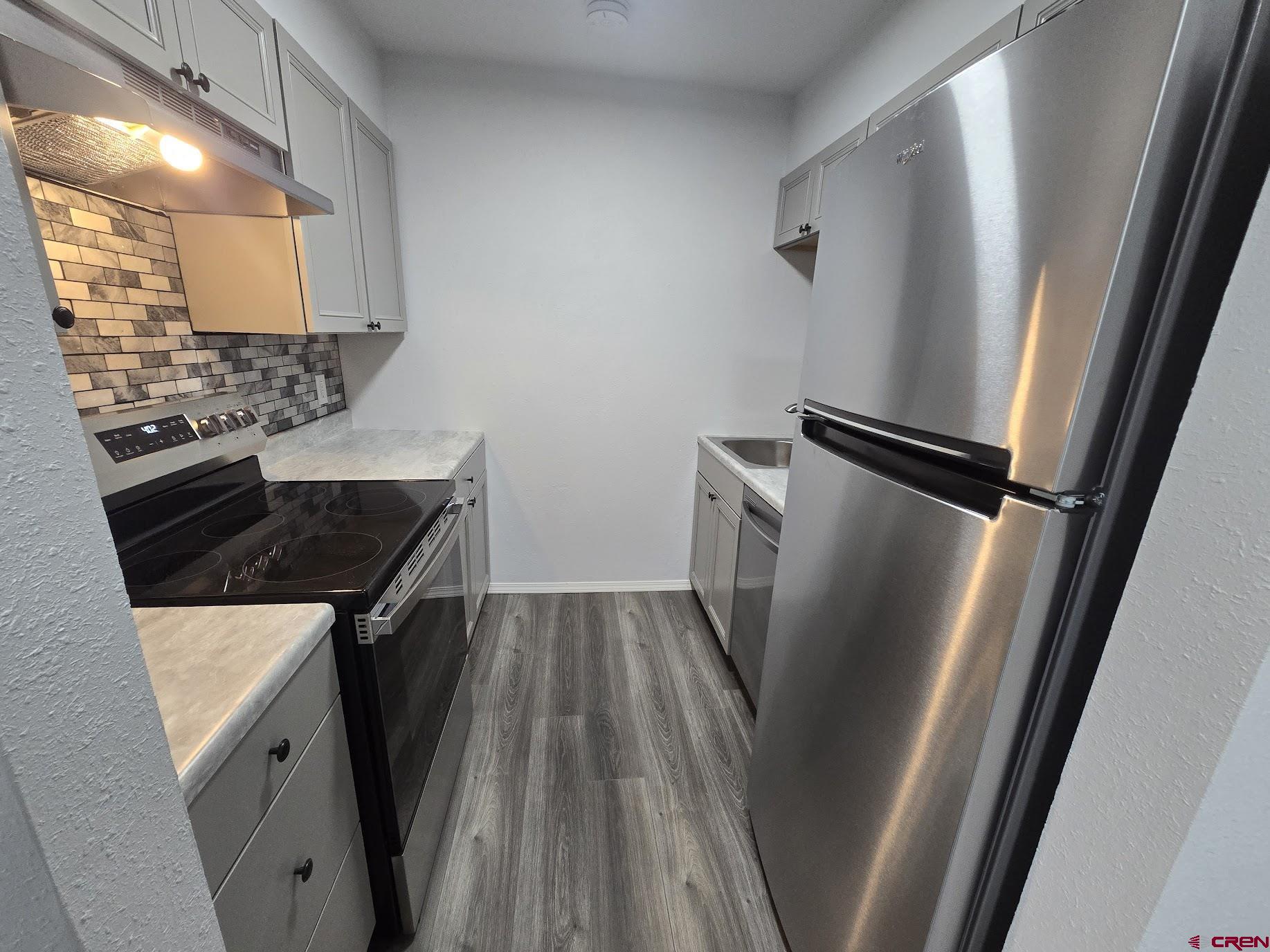 34237 Highway 550, Unit 9 Durango, CO 81301 - Photo 15 of 18 a kitchen with wooden floor and electronic appliances