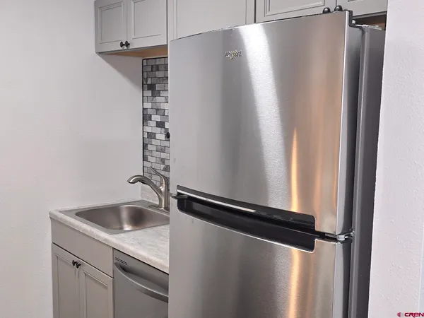 a stove top oven sitting inside of a kitchen