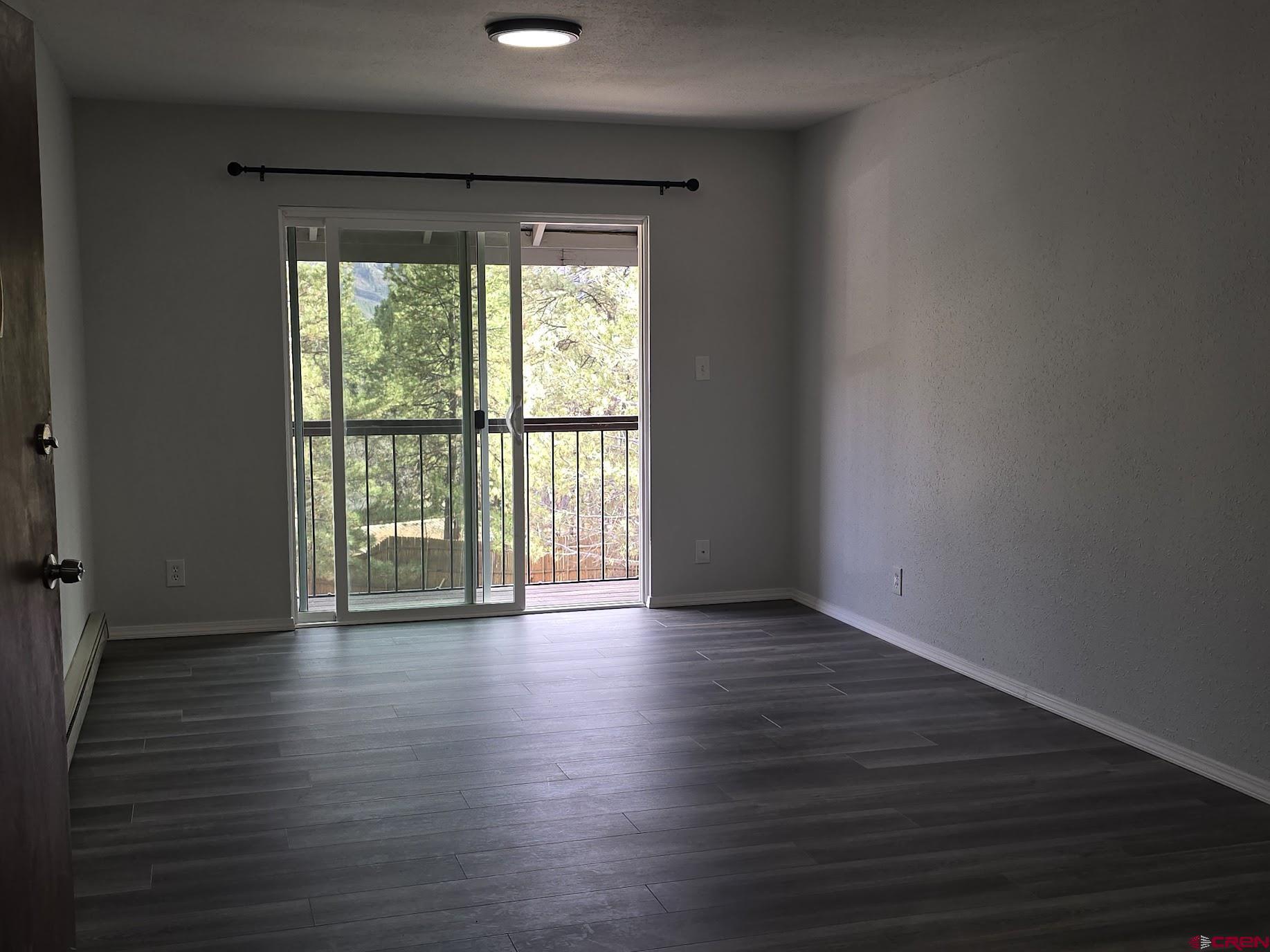 34237 Highway 550, Unit 9 Durango, CO 81301 - Photo 18 of 18 a view of an empty room with wooden floor and a window