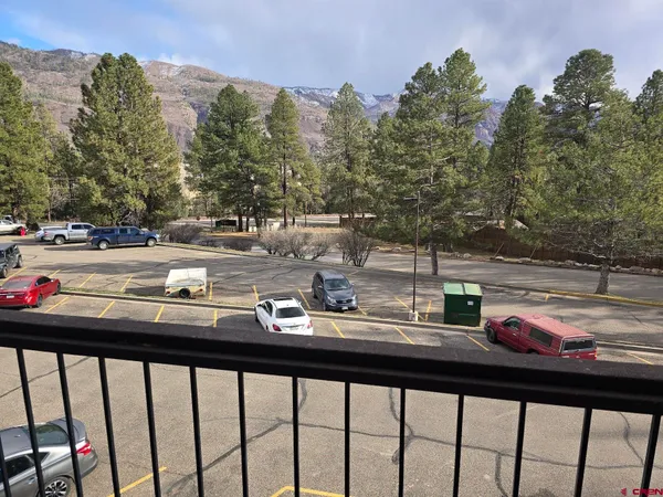 a view of a room with wooden floor and windows