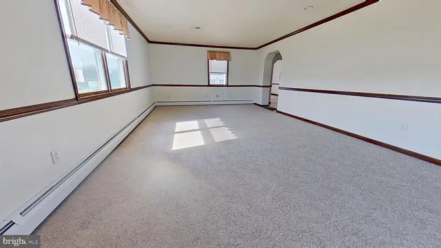 a view of an empty room with windows