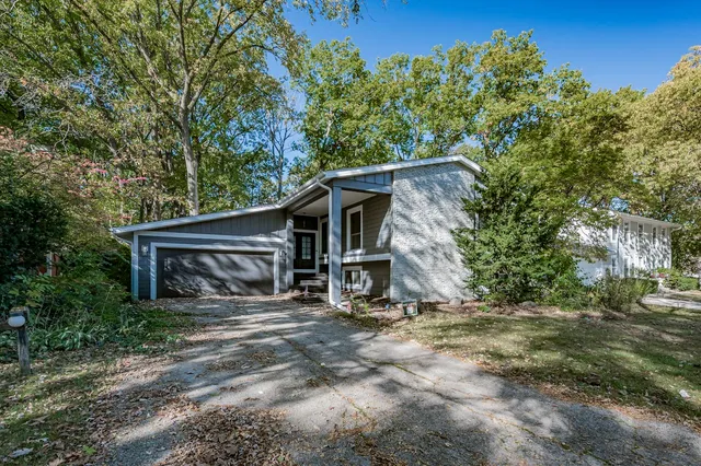 a view of a house with large trees