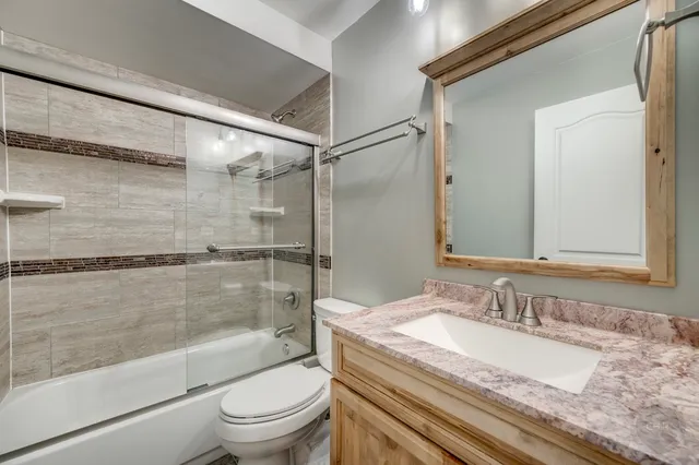 a open kitchen with a sink and a large window