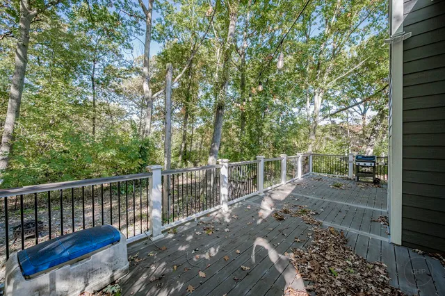 a front view of house with yard and trees around