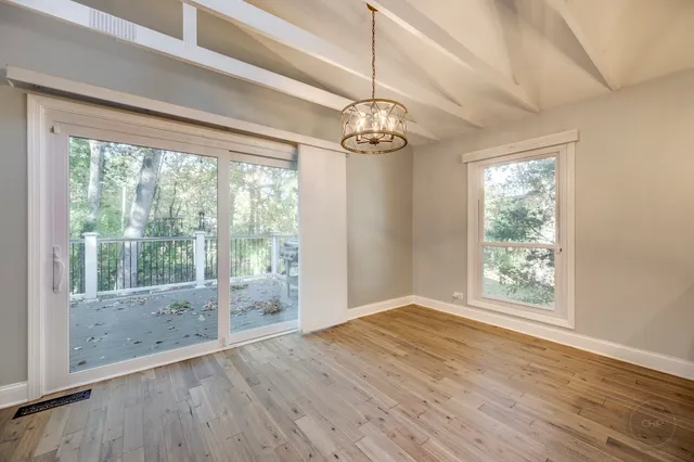 a kitchen with stainless steel appliances granite countertop a refrigerator a sink dishwasher a stove and a oven with wooden floor