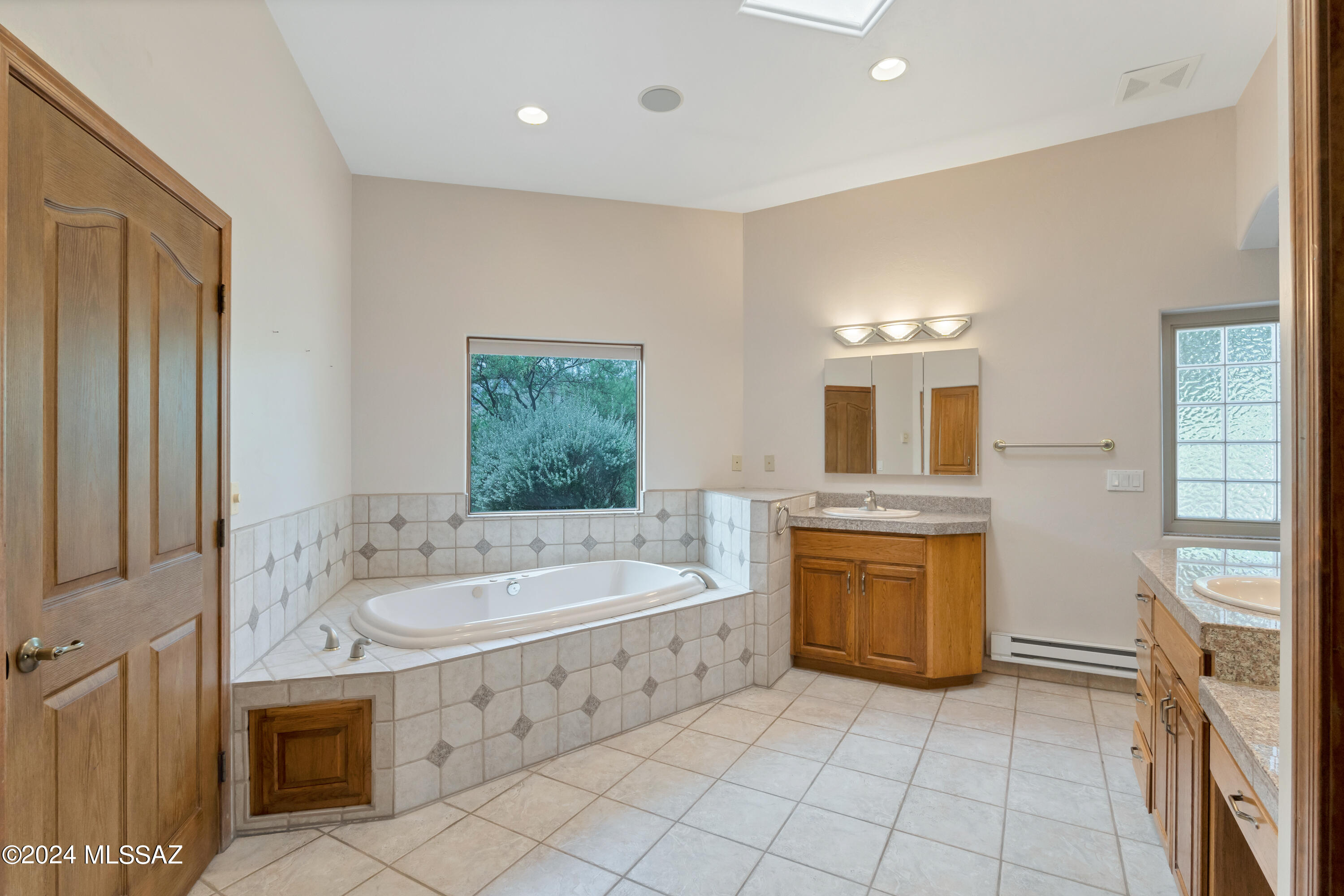 4001 North Harrison Road Tucson, AZ 85749 - Photo 30 of 50 a bathroom with a tub sink and a mirror