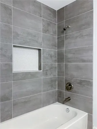 a bathroom with a toilet and bathtub