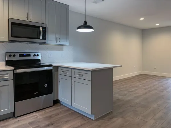 a kitchen with stainless steel appliances a refrigerator and a stove top oven