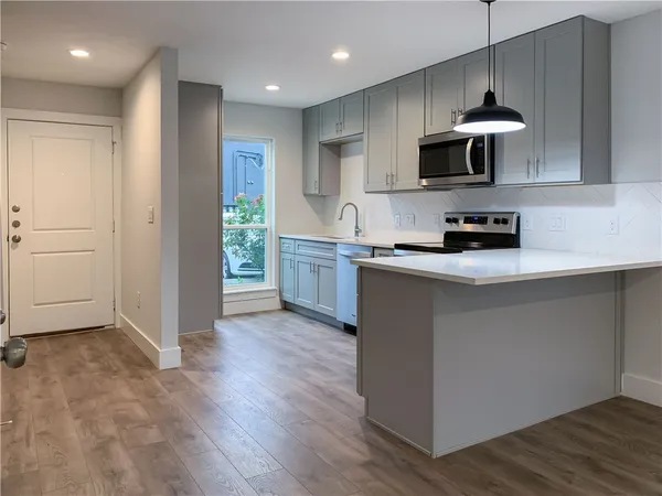 a view of walk in closet with wooden floor