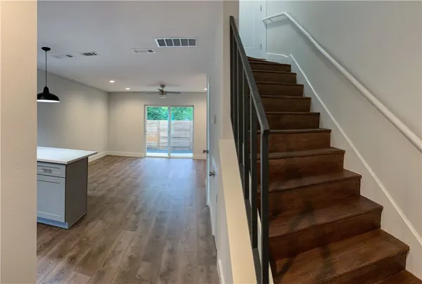 a view of entryway and hall with wooden floor