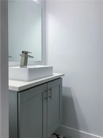 a bathroom with a sink a vanity and a mirror