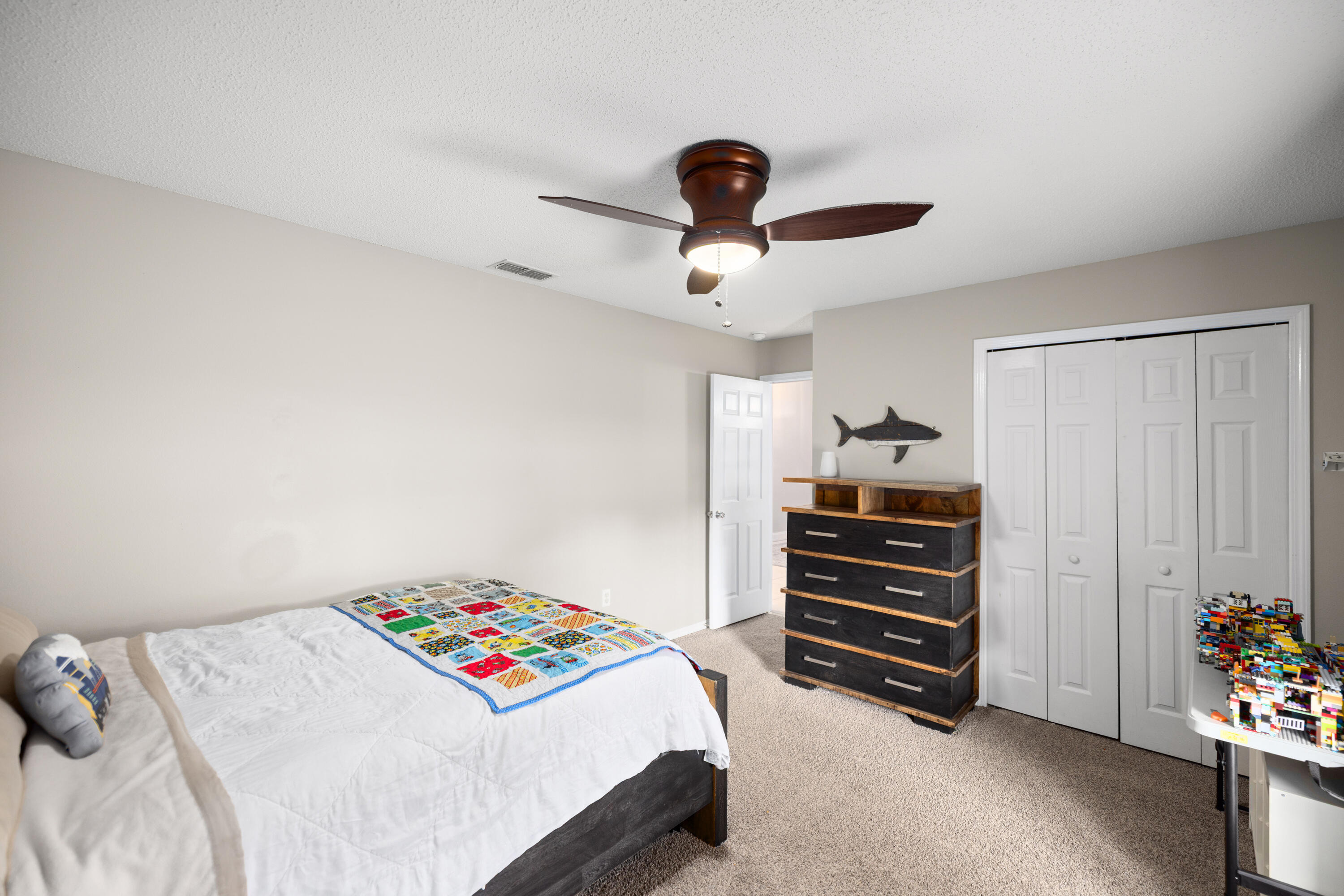 202 Limestone Circle Crestview, FL 32539 - Photo 28 of 49 a bedroom with a bed and a chandelier
