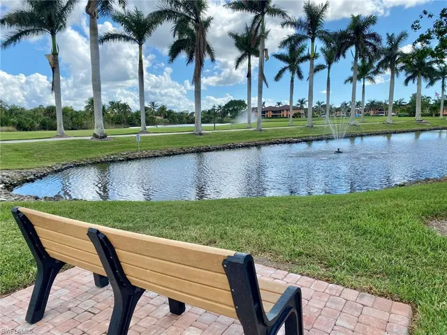 a view of a park with furniture and lake view