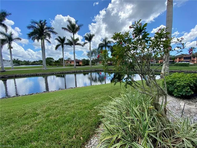 a view of a lake with a house in the background