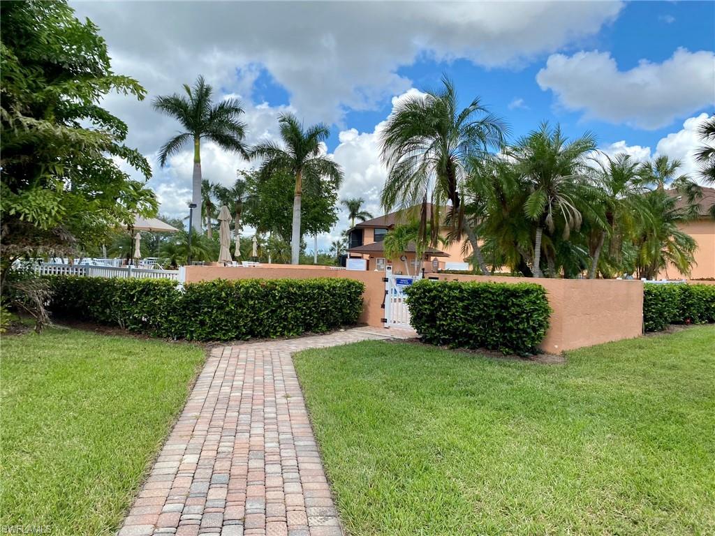 1516 Mainsail Drive, Unit 2 Naples, FL 34114 - Photo 18 of 45 a view of a backyard with palm trees