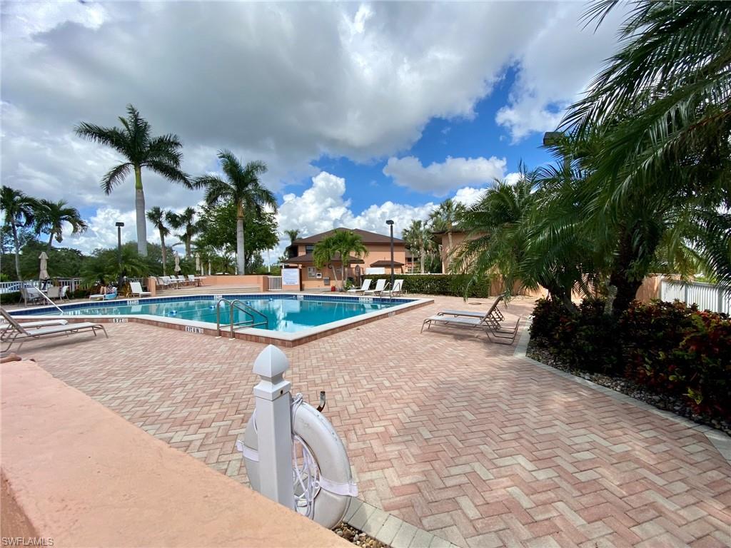 1516 Mainsail Drive, Unit 2 Naples, FL 34114 - Photo 19 of 45 a view of a street with a building in the background
