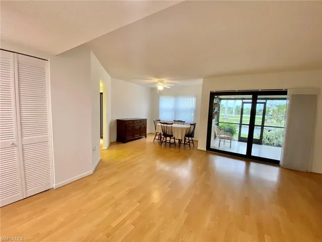 a view of a livingroom with furniture and floor to ceiling window