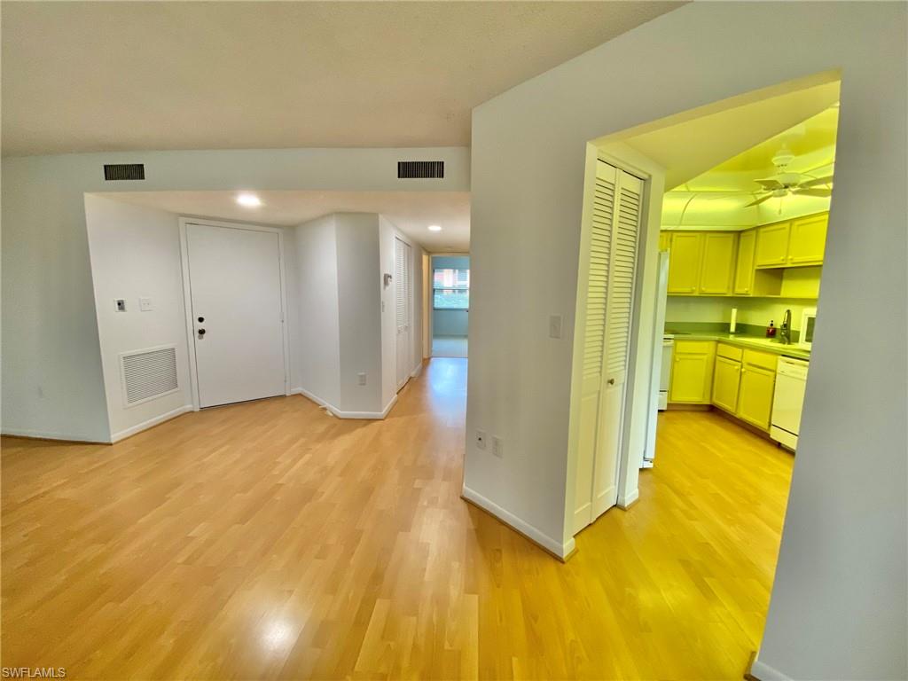 1516 Mainsail Drive, Unit 2 Naples, FL 34114 - Photo 23 of 45 a view of a big room with wooden floor and windows