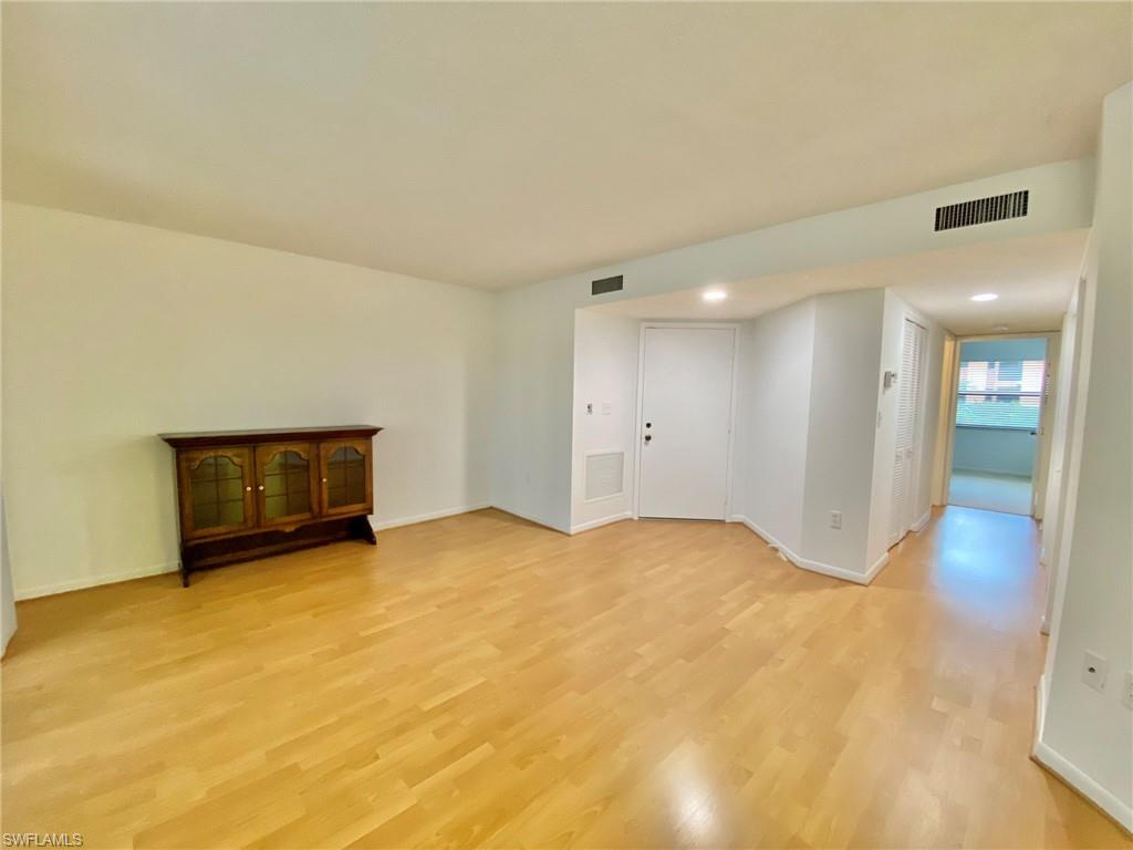 1516 Mainsail Drive, Unit 2 Naples, FL 34114 - Photo 3 of 45 a view of an empty room with a fireplace