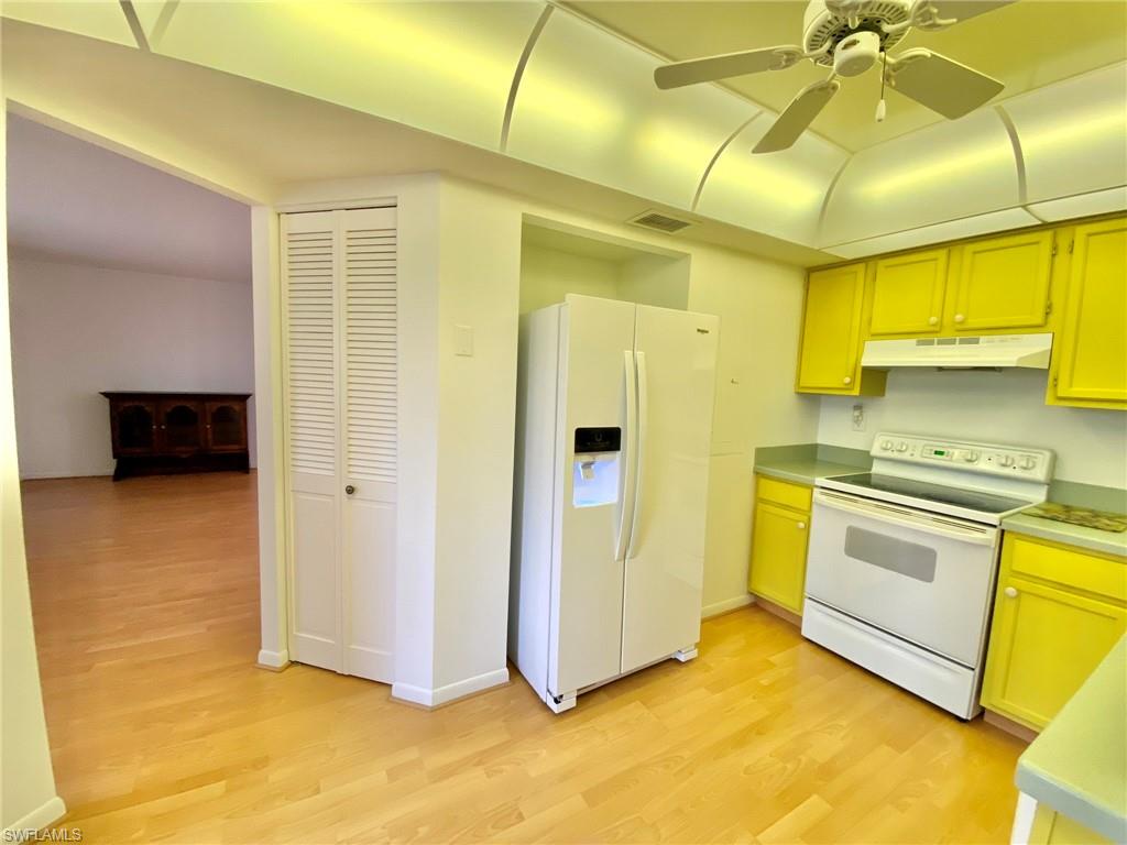 1516 Mainsail Drive, Unit 2 Naples, FL 34114 - Photo 31 of 45 a kitchen with stainless steel appliances granite countertop a refrigerator and a stove top oven