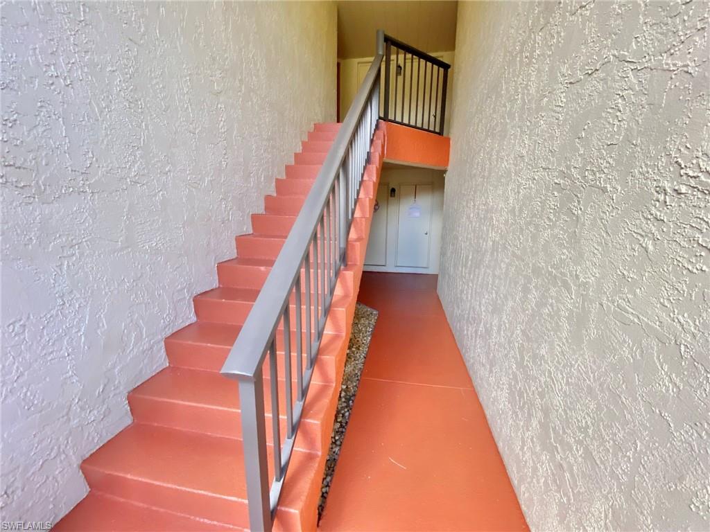 1516 Mainsail Drive, Unit 2 Naples, FL 34114 - Photo 45 of 45 a view of staircase with wooden floor and white walls
