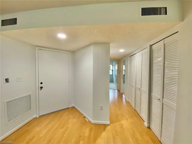 a view of a hallway with wooden floor