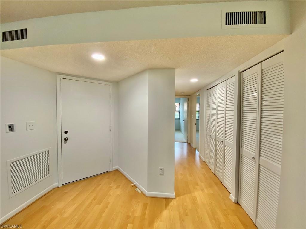 1516 Mainsail Drive, Unit 2 Naples, FL 34114 - Photo 5 of 45 a view of a hallway with wooden floor