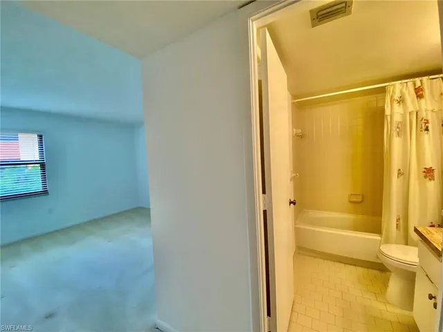 a bathroom with a shower and a toilet