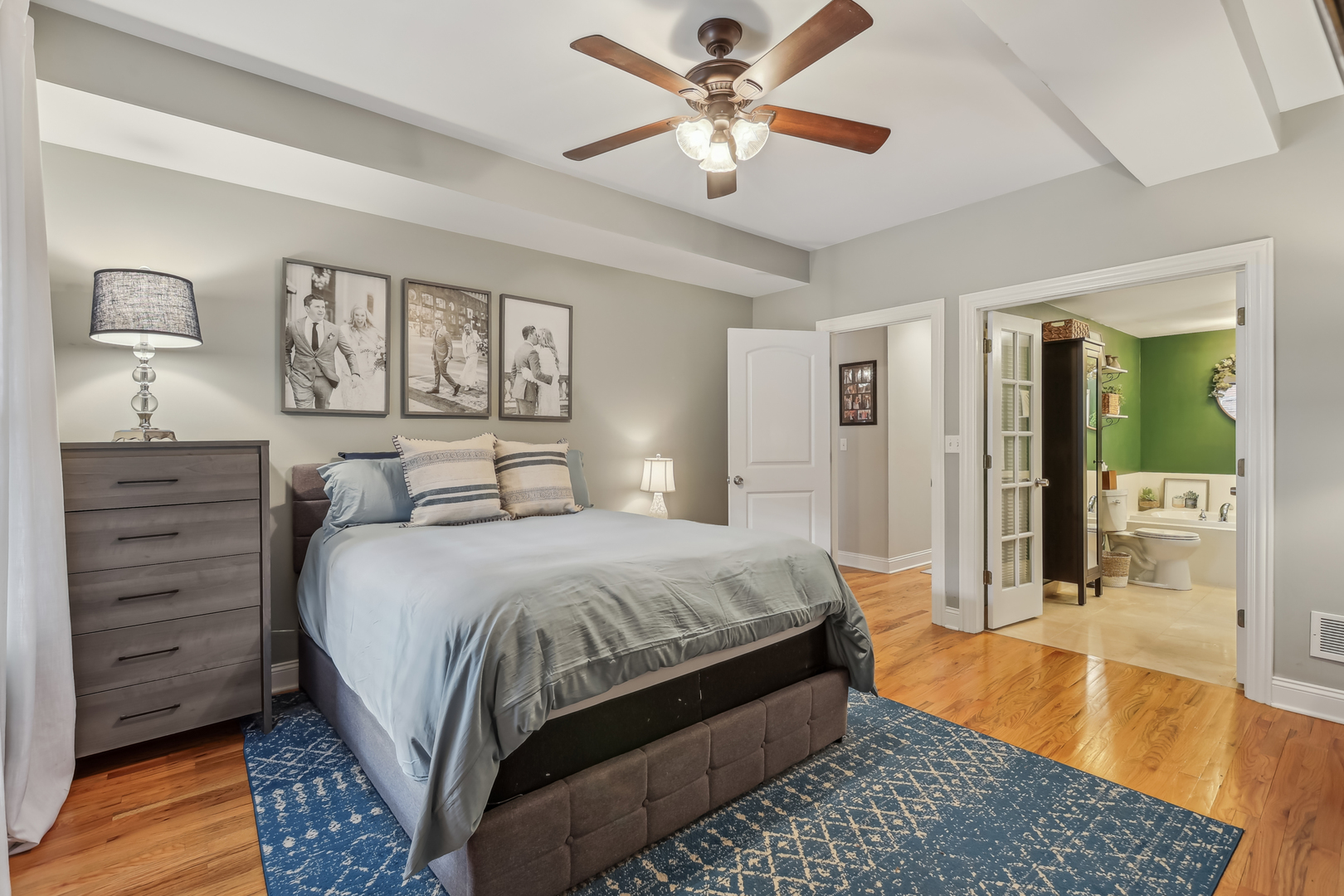 1025 West Madison Street, Unit 1 Chicago, IL 60607 - Photo 9 of 21 a bedroom with a large bed a chandelier and closet