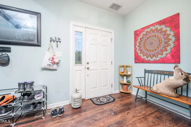 a bedroom with furniture and wooden floor