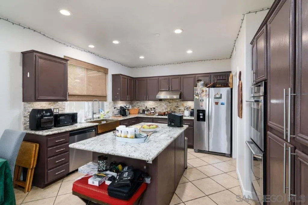 569 Inverlochy Drive Fallbrook, CA 92028 - Photo 12 of 46 a kitchen with a refrigerator a stove a sink and a refrigerator