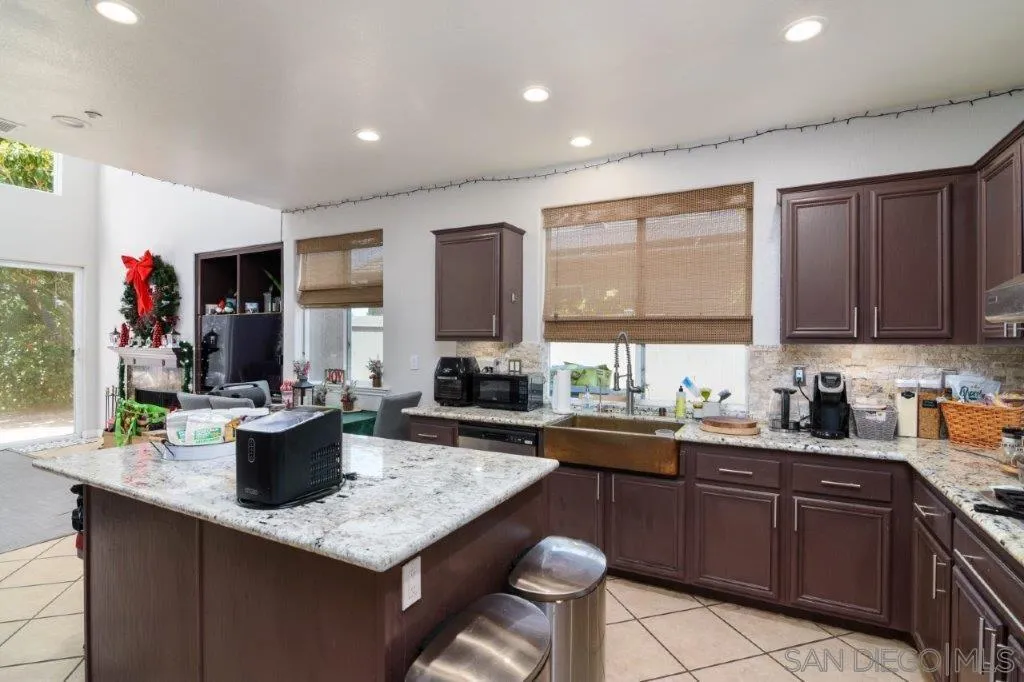 569 Inverlochy Drive Fallbrook, CA 92028 - Photo 13 of 46 a kitchen with a sink and cabinets