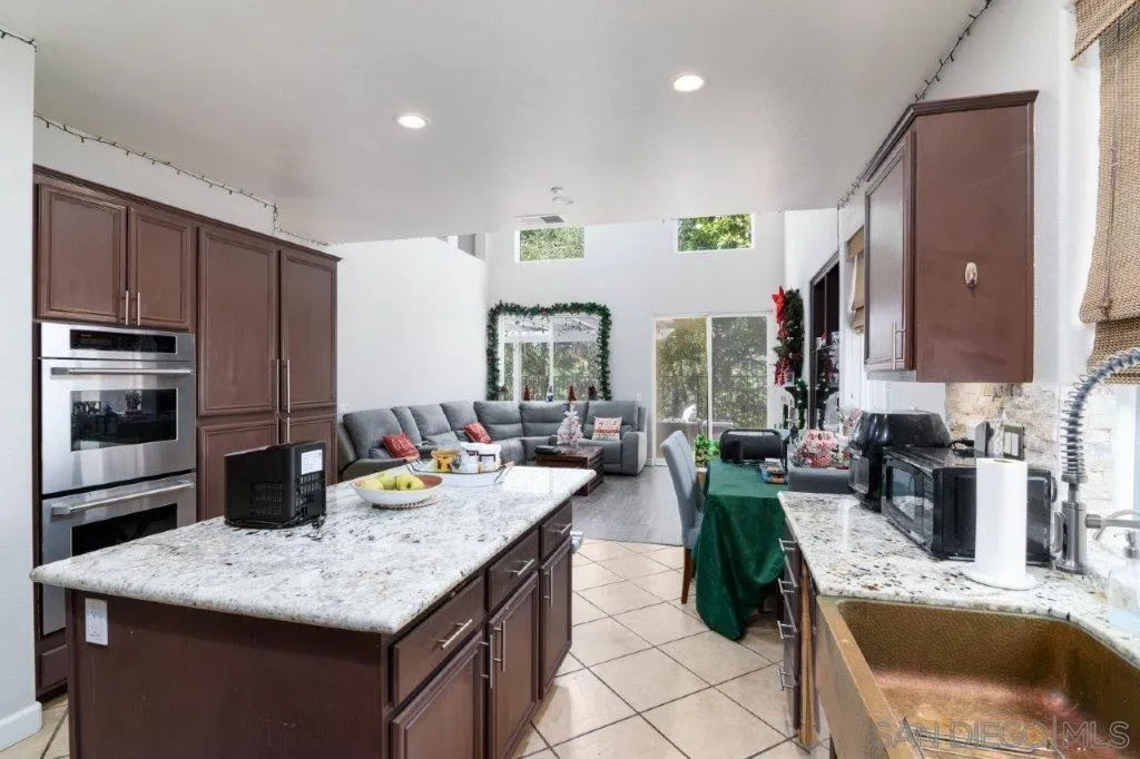 569 Inverlochy Drive Fallbrook, CA 92028 - Photo 15 of 46 a kitchen with granite countertop lots of counter top space and stainless steel appliances