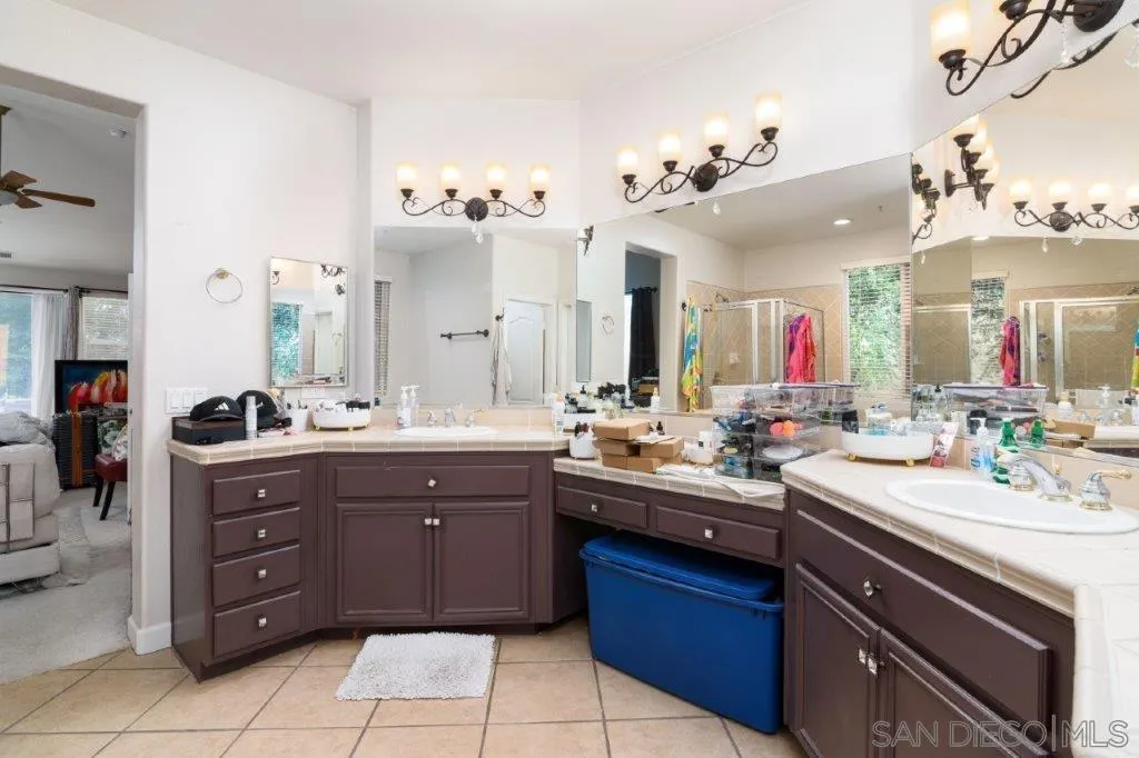 569 Inverlochy Drive Fallbrook, CA 92028 - Photo 19 of 46 a bathroom with a sink vanity and a mirror