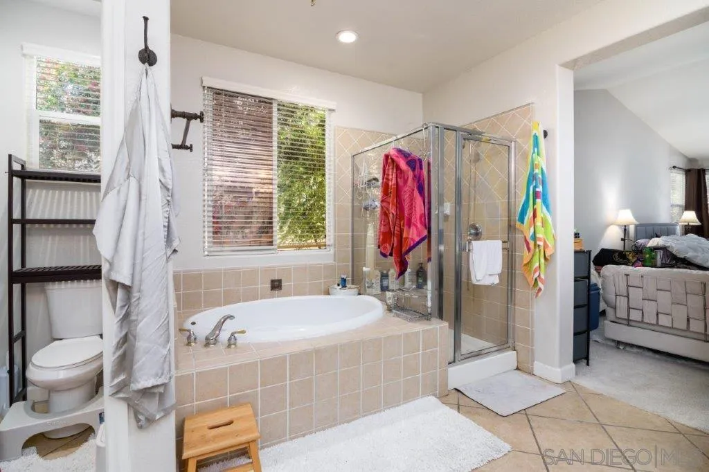 569 Inverlochy Drive Fallbrook, CA 92028 - Photo 20 of 46 a bathroom with a tub shower and a sink