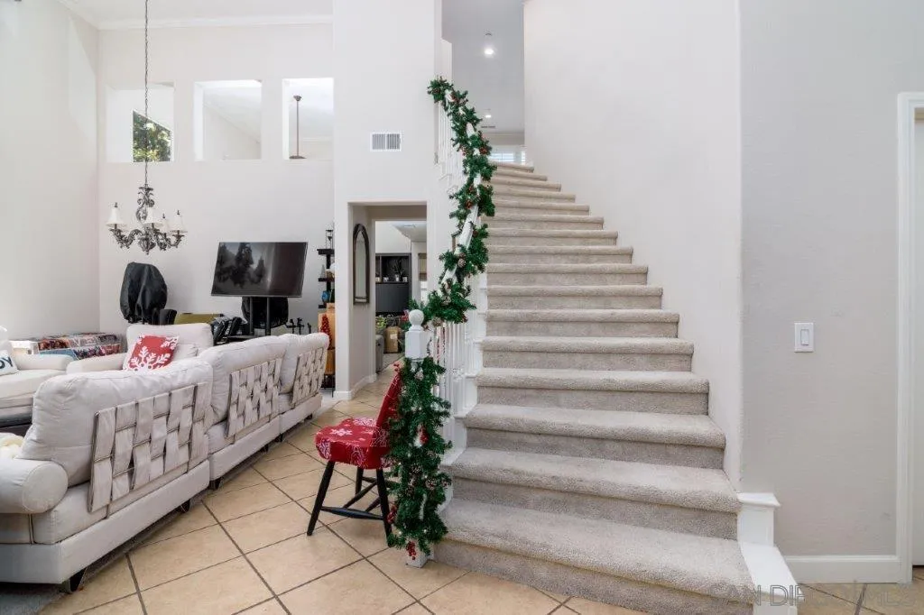 569 Inverlochy Drive Fallbrook, CA 92028 - Photo 21 of 46 a bed room with a bed and a chandelier