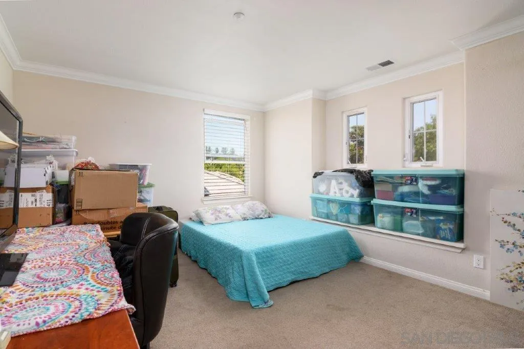 569 Inverlochy Drive Fallbrook, CA 92028 - Photo 24 of 46 a bedroom with a bed and window