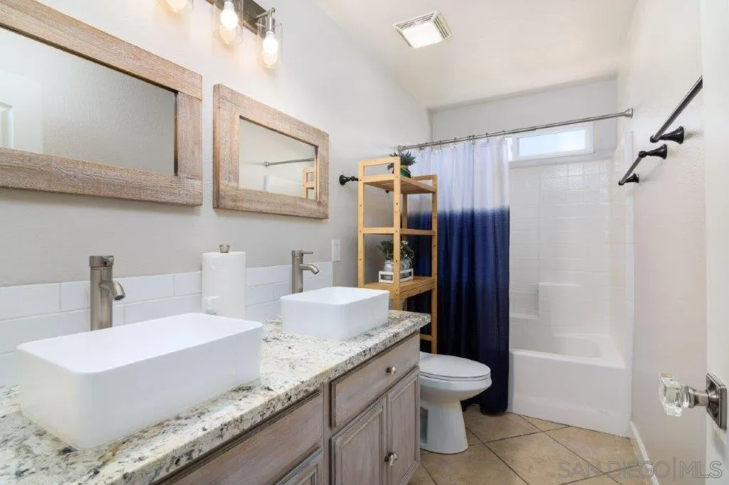 569 Inverlochy Drive Fallbrook, CA 92028 - Photo 26 of 46 a bathroom with a granite countertop sink toilet and shower