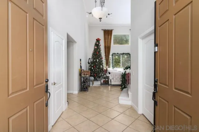a view of a hallway and a livingroom with furniture