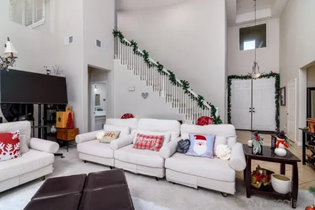 a living room with furniture and a chandelier