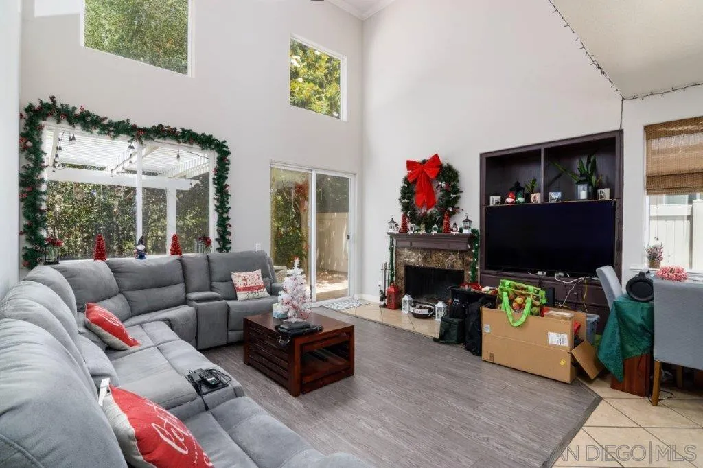 569 Inverlochy Drive Fallbrook, CA 92028 - Photo 9 of 46 a living room with furniture large window and a fireplace
