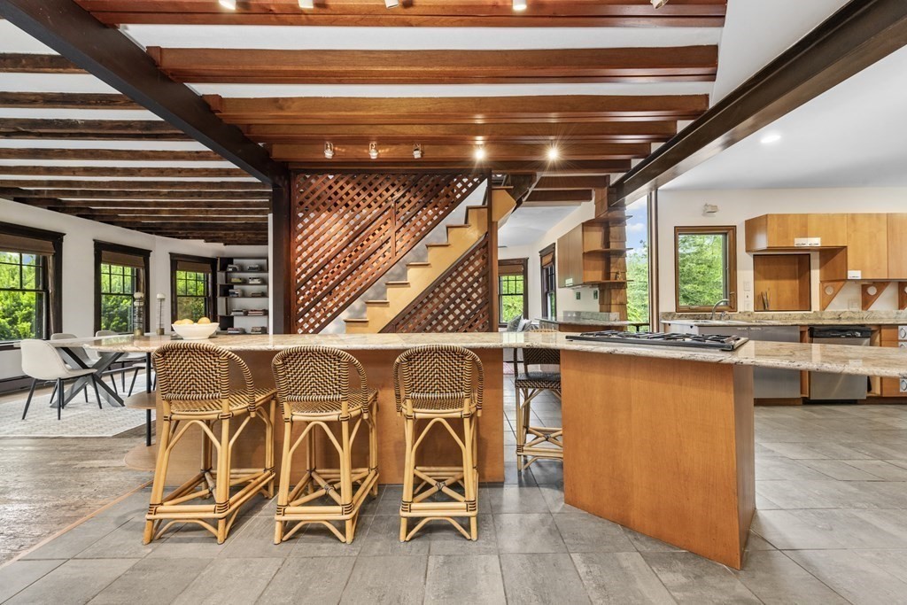 75 Kendall Road Lexington, MA 02421 - Photo 8 of 22 a roof deck with table and chairs a barbeque with wooden floor and plants