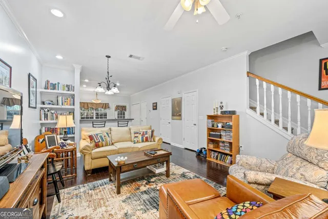 a living room with furniture a rug and a chandelier