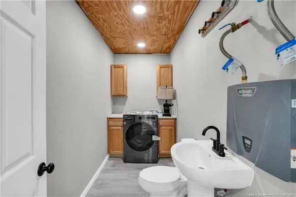 a bathroom with a toilet sink and mirror