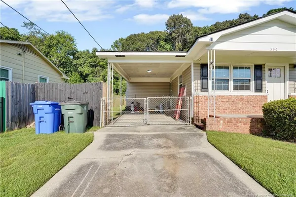a view of an house with backyard porch and furniture