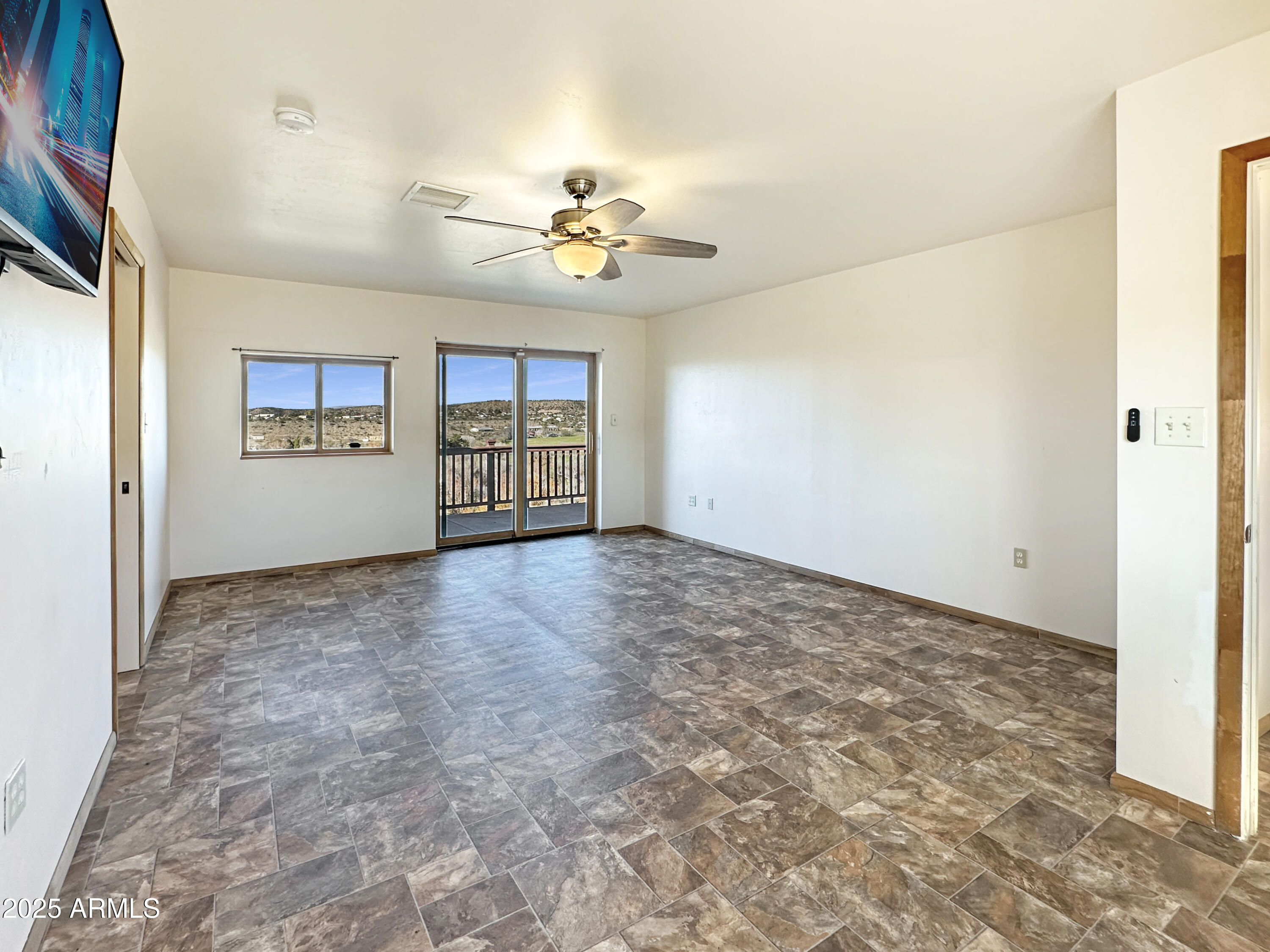 4580 Roundup Road Rimrock, AZ 86335 - Photo 12 of 21 a view of a livingroom with a chandelier fan and kitchen view