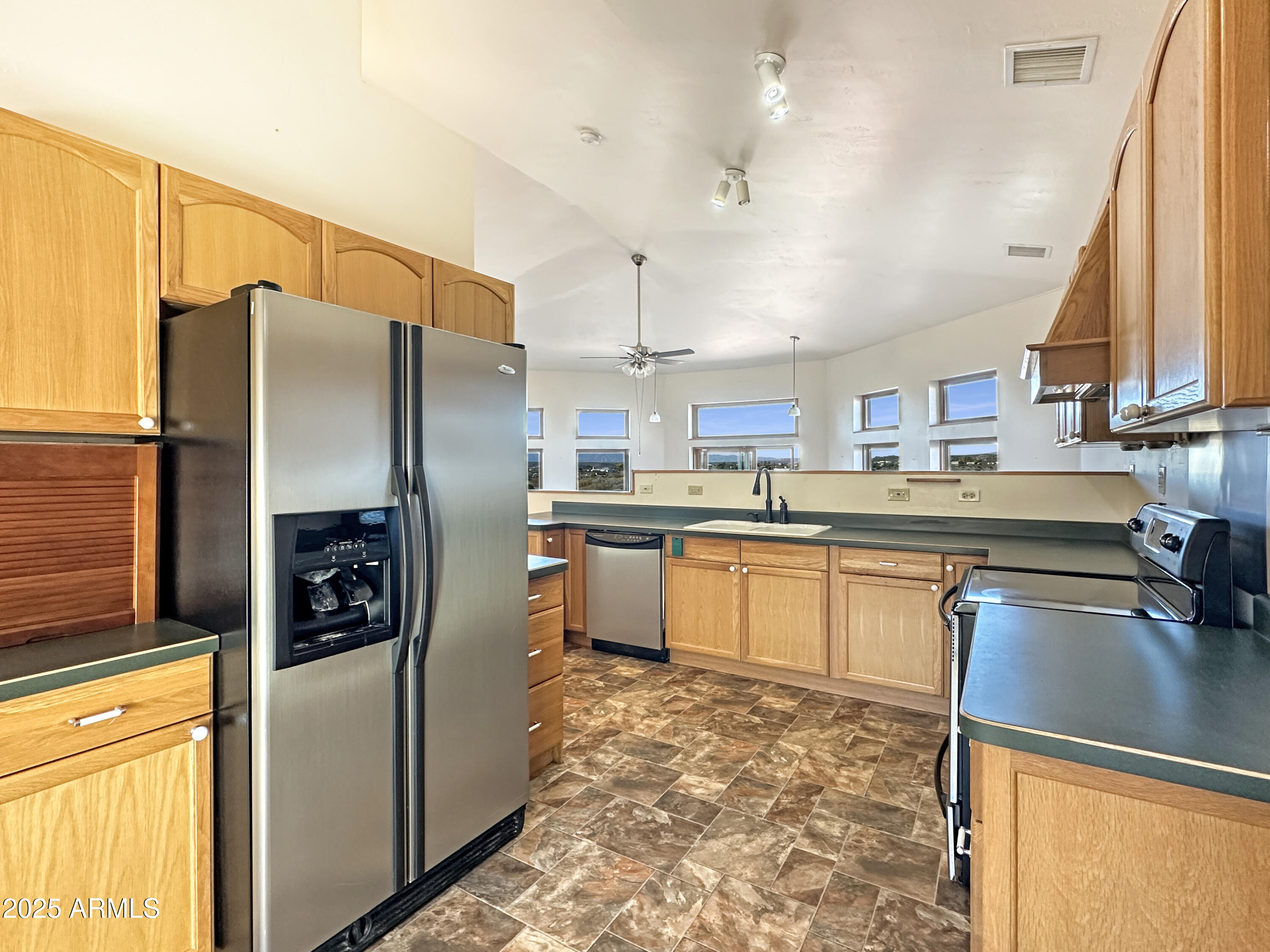 4580 Roundup Road Rimrock, AZ 86335 - Photo 10 of 21 a kitchen with stainless steel appliances granite countertop a refrigerator a stove and a sink